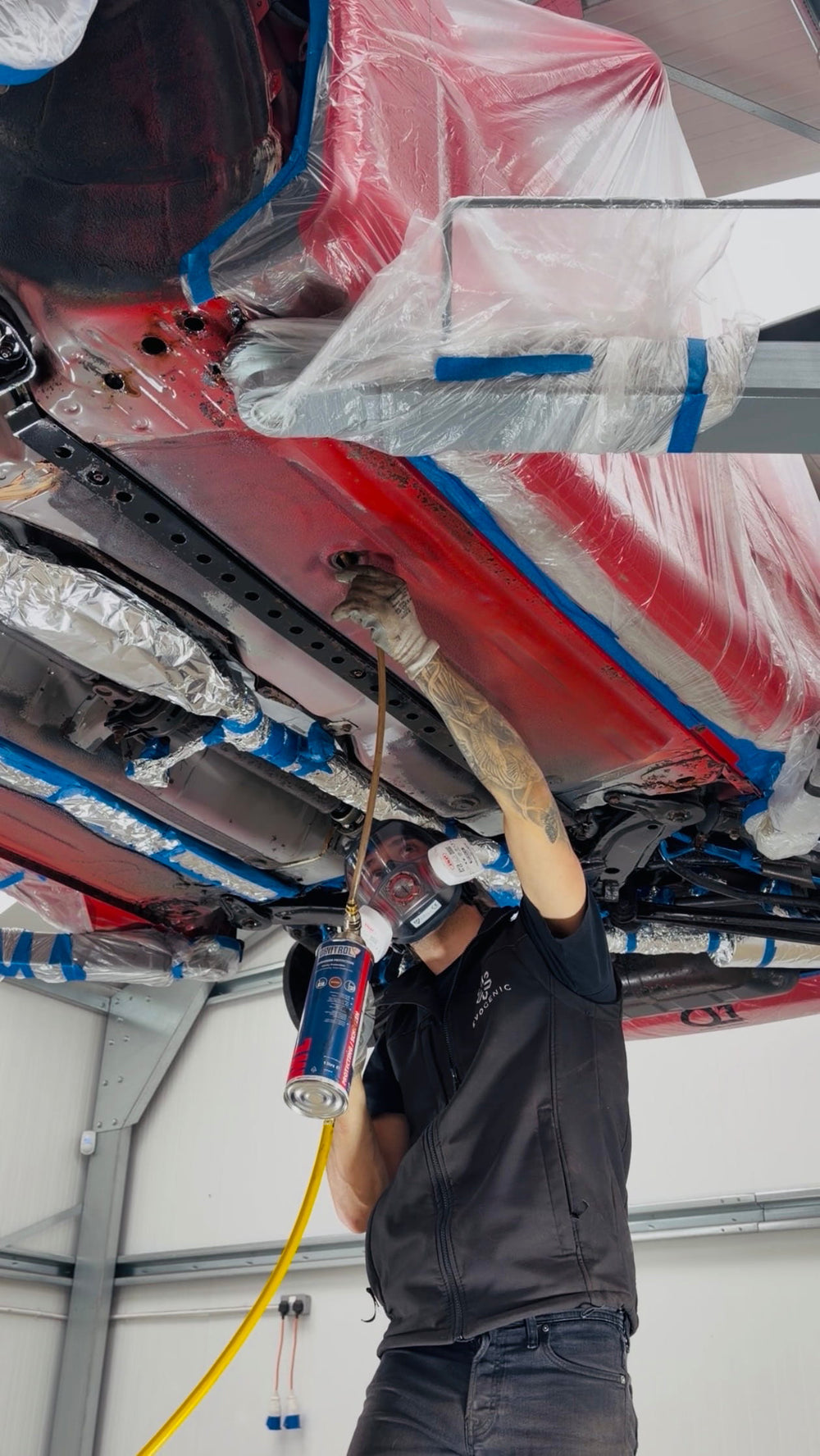 Cavity wax injection and rust treatment on a red Mitsubishi 