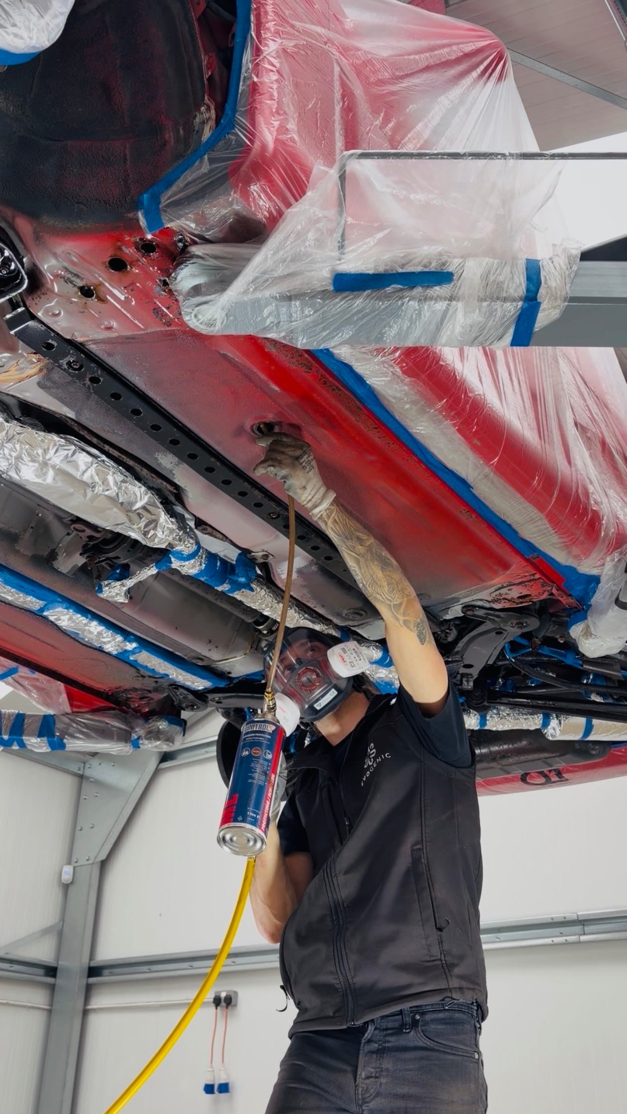 Cavity wax injection and rust treatment on a red Mitsubishi 