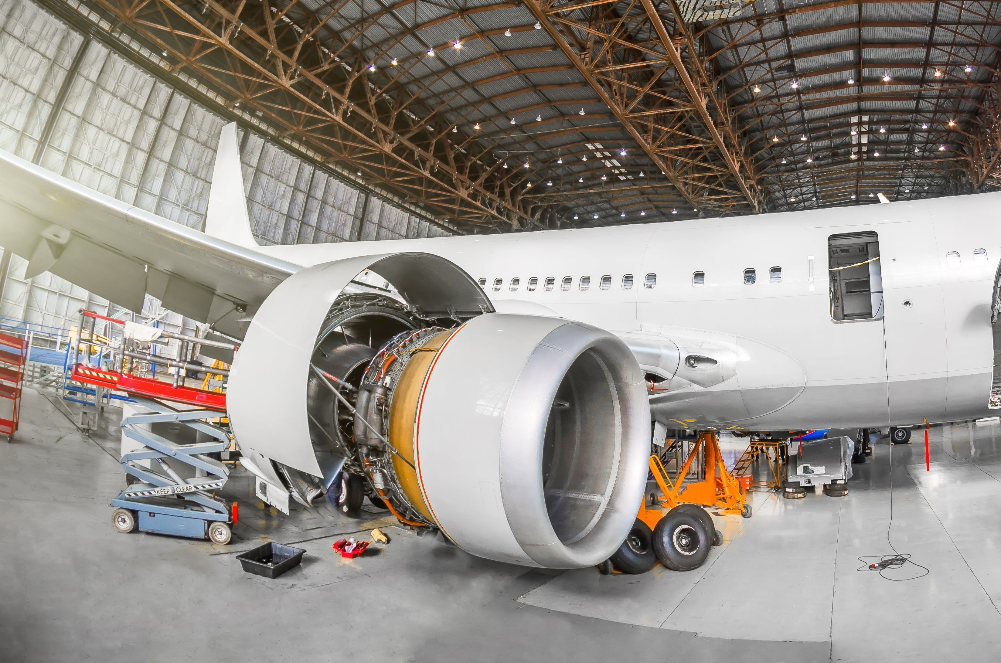 Airplane engine being prepared for dry ice cleaning in a hangar 