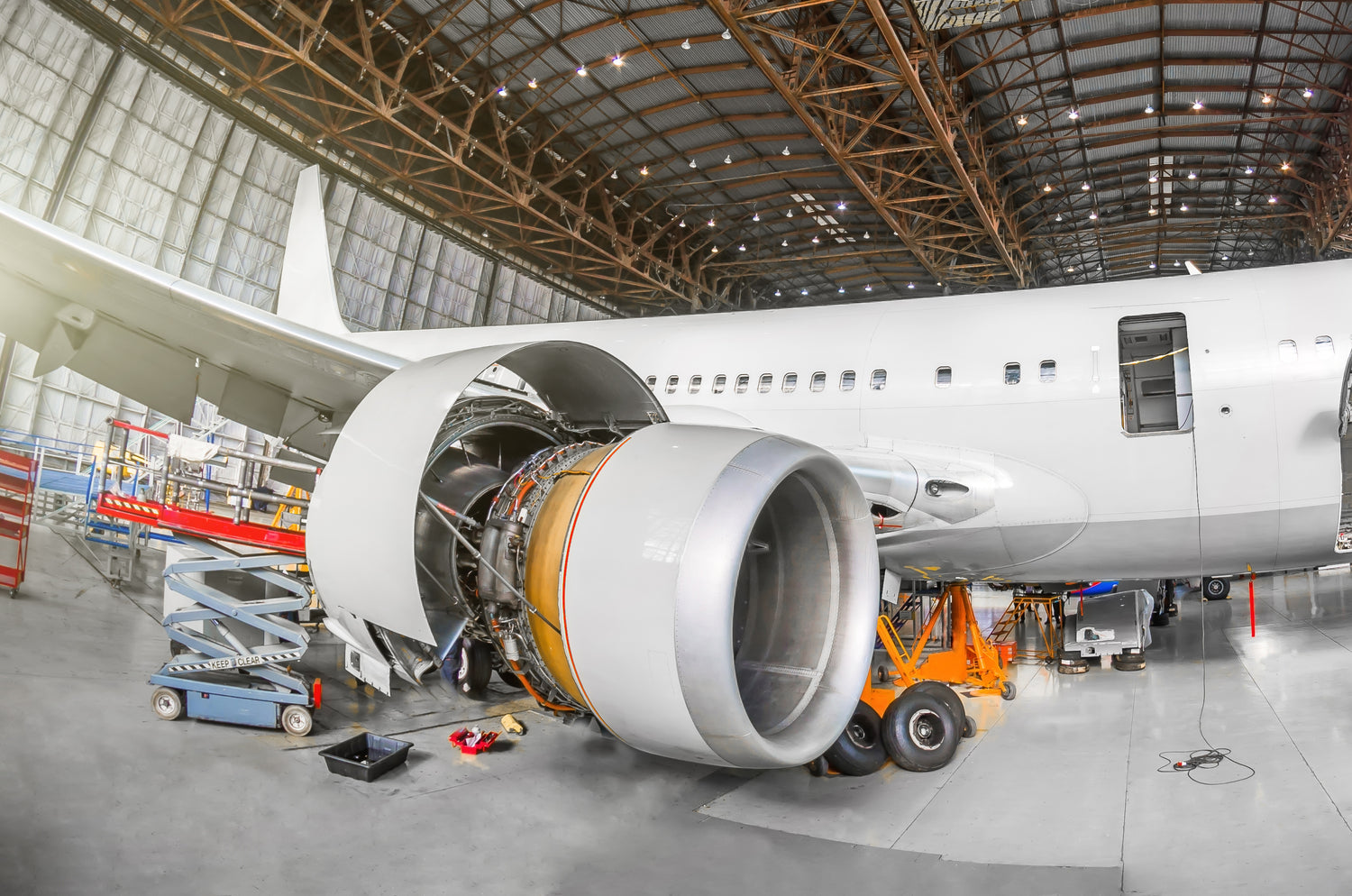 Airplane engine being prepared for dry ice cleaning in a hangar 