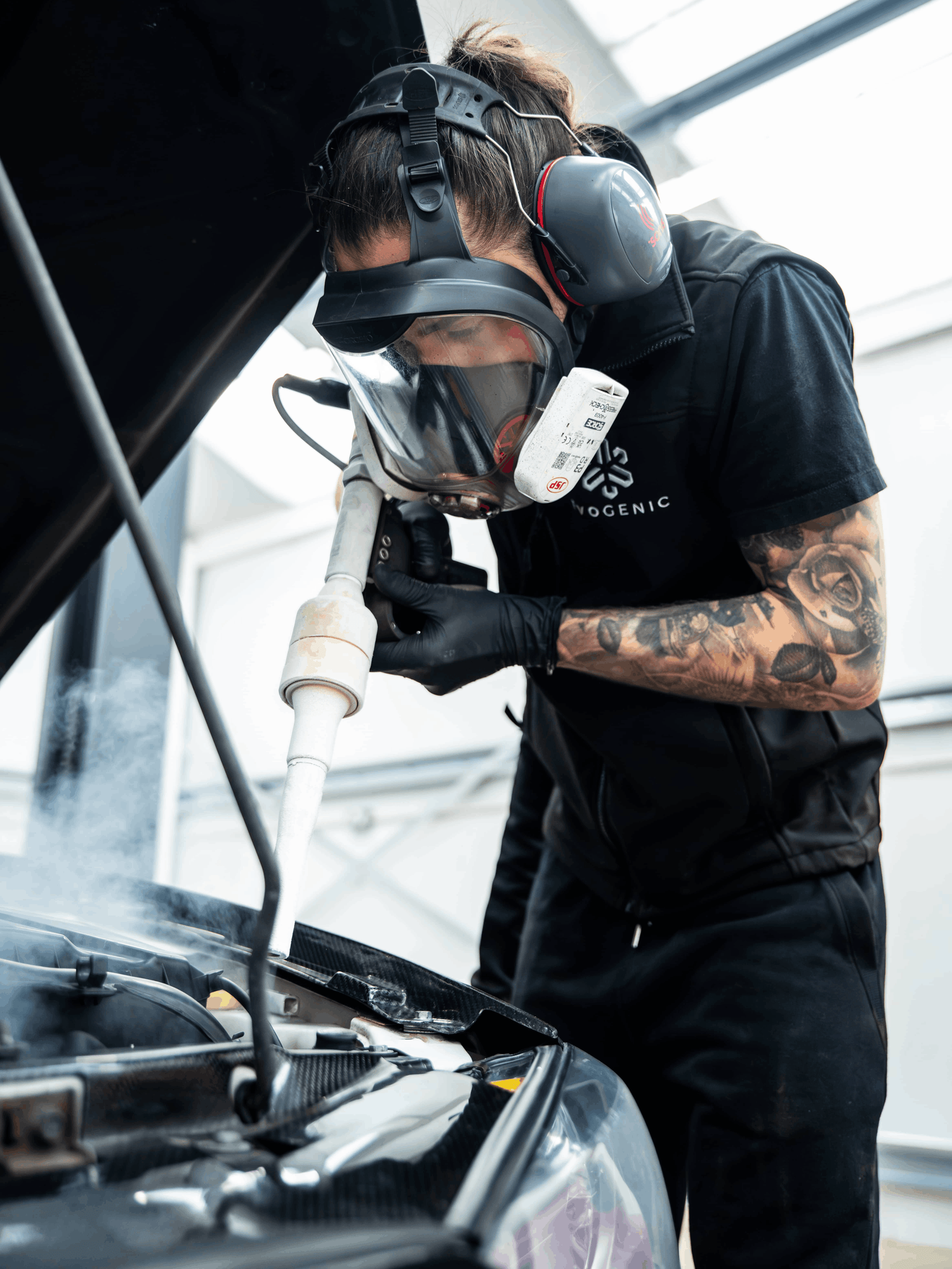 Dry ice blasting a car in a garage