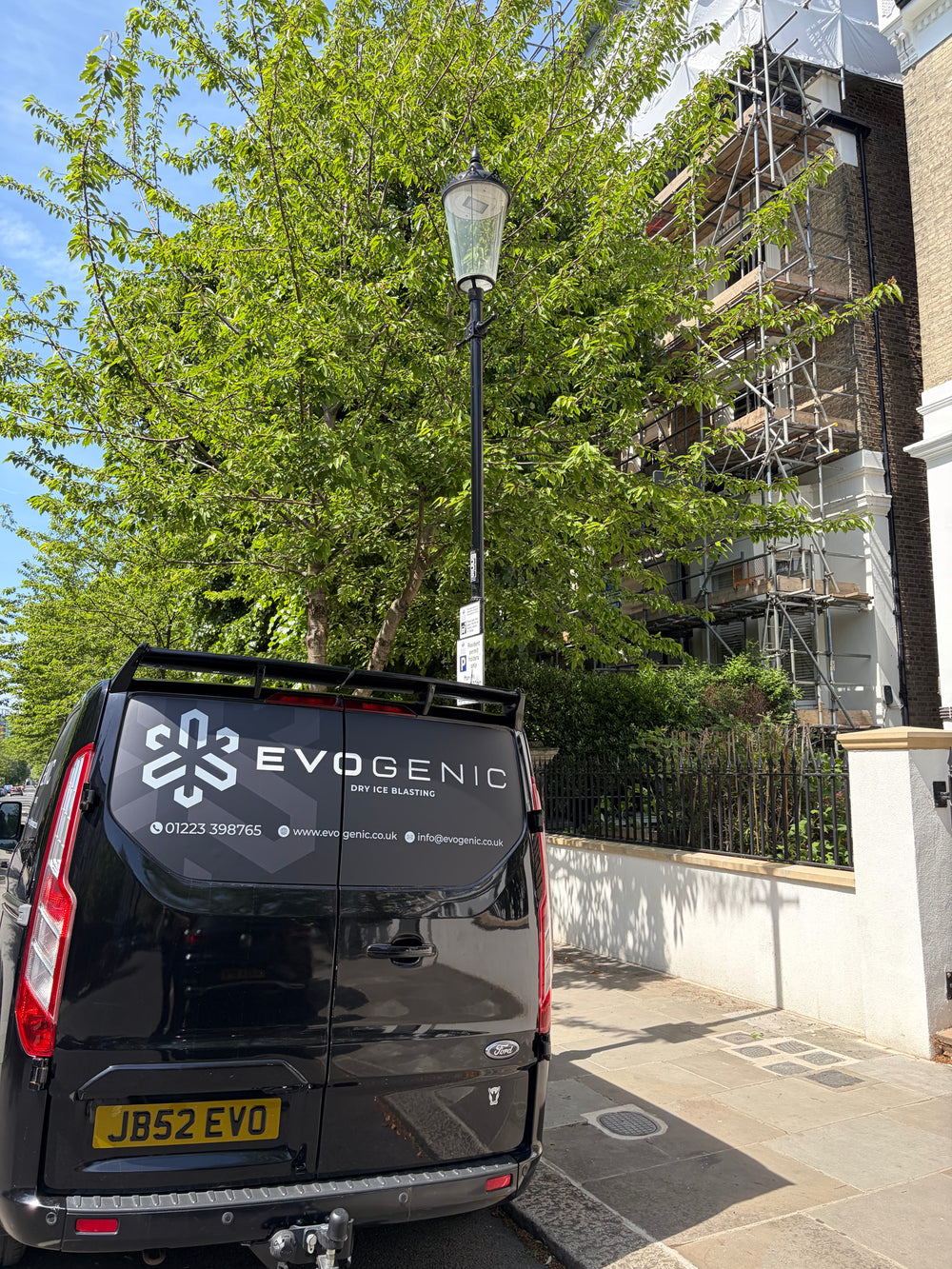 EVOGENIC van parked on London street outside fire damaged property