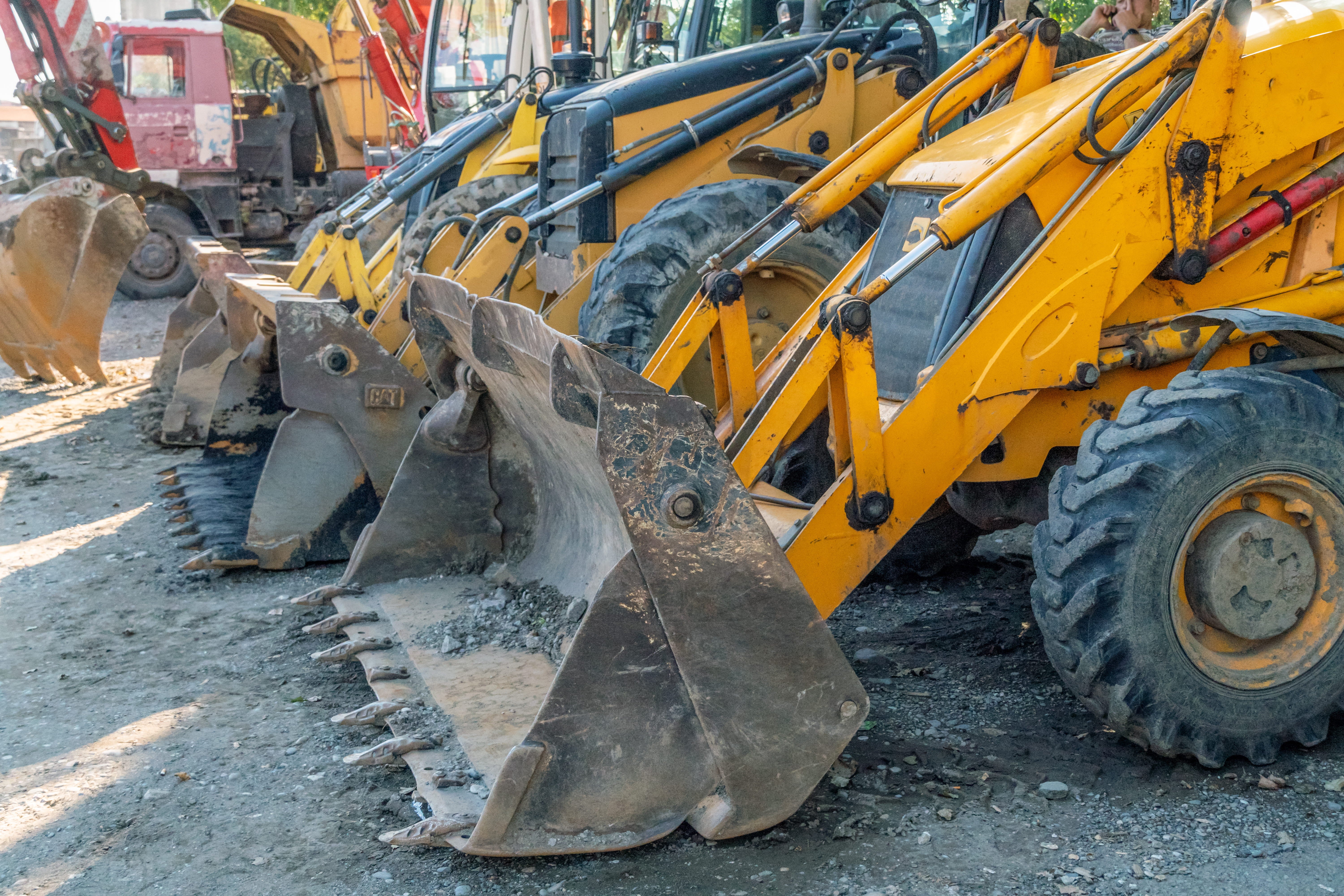 Excavators and diggers in plant hire yard before for dry ice blasting 
