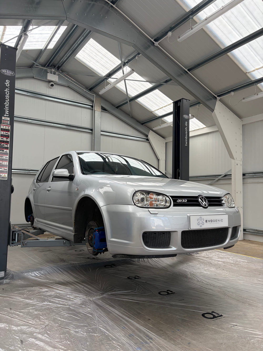 Volkswagen Mk4 R32 on a lift for full underbody dry ice blasting and underbody restoration