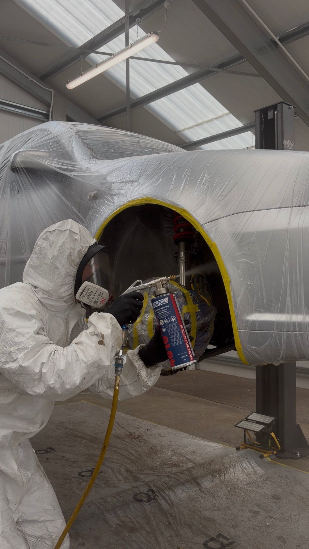 EVOGENIC technician applying underbody protection to volkswagen r32