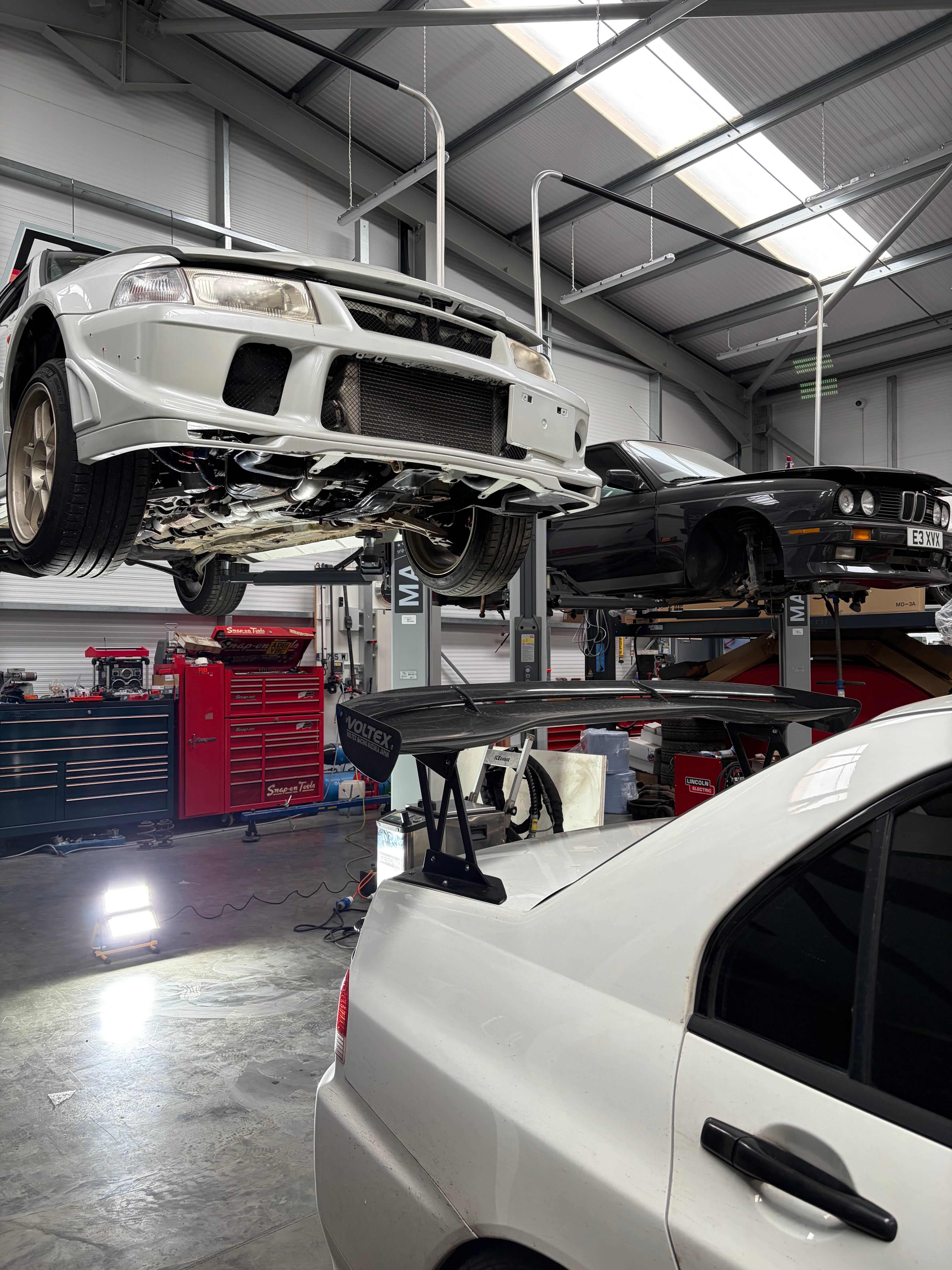 Dry ice blasting facility with cars on lifts. 