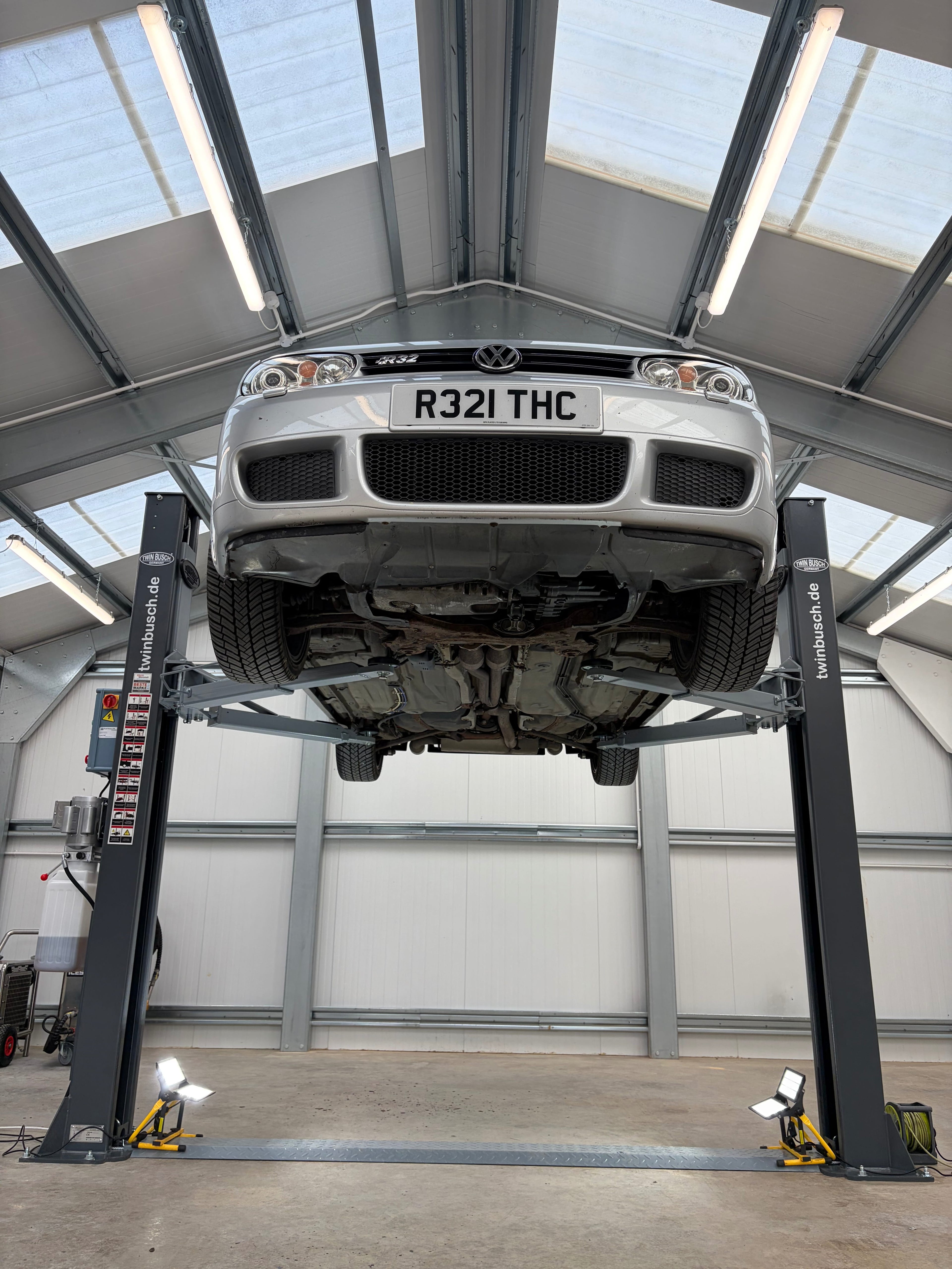 R32 golf on lift prepared for underbody restoration