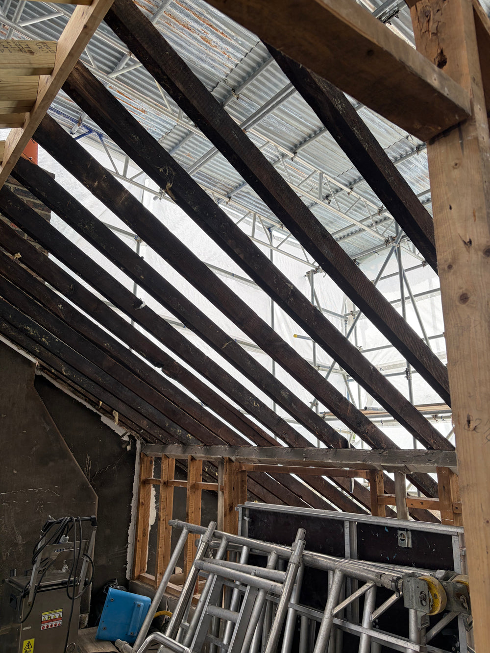 Fire damaged roof timbers in London property before dry ice blasting