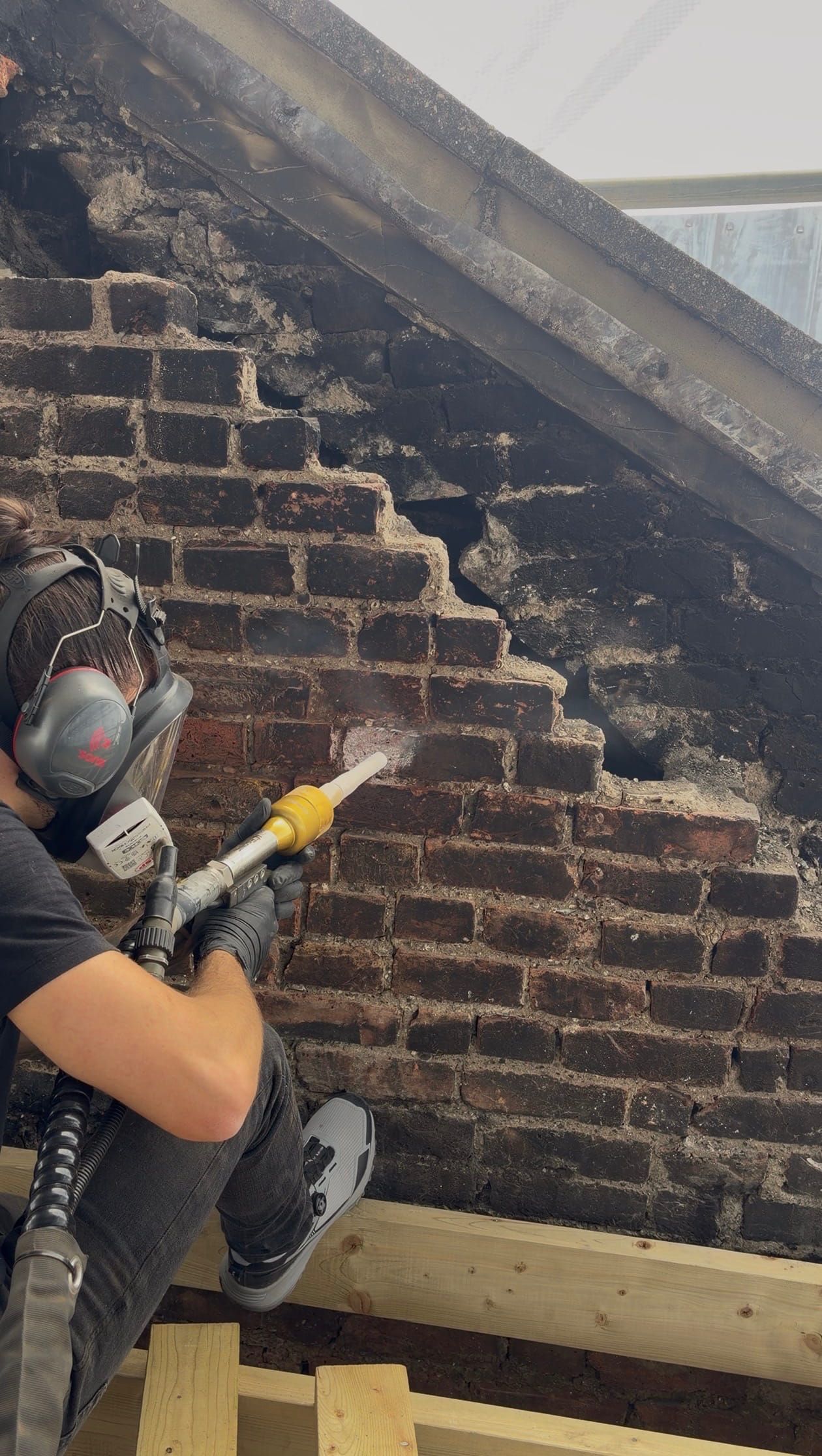 Dry ice blasting fire, soot and smoke damage off a wall in a property