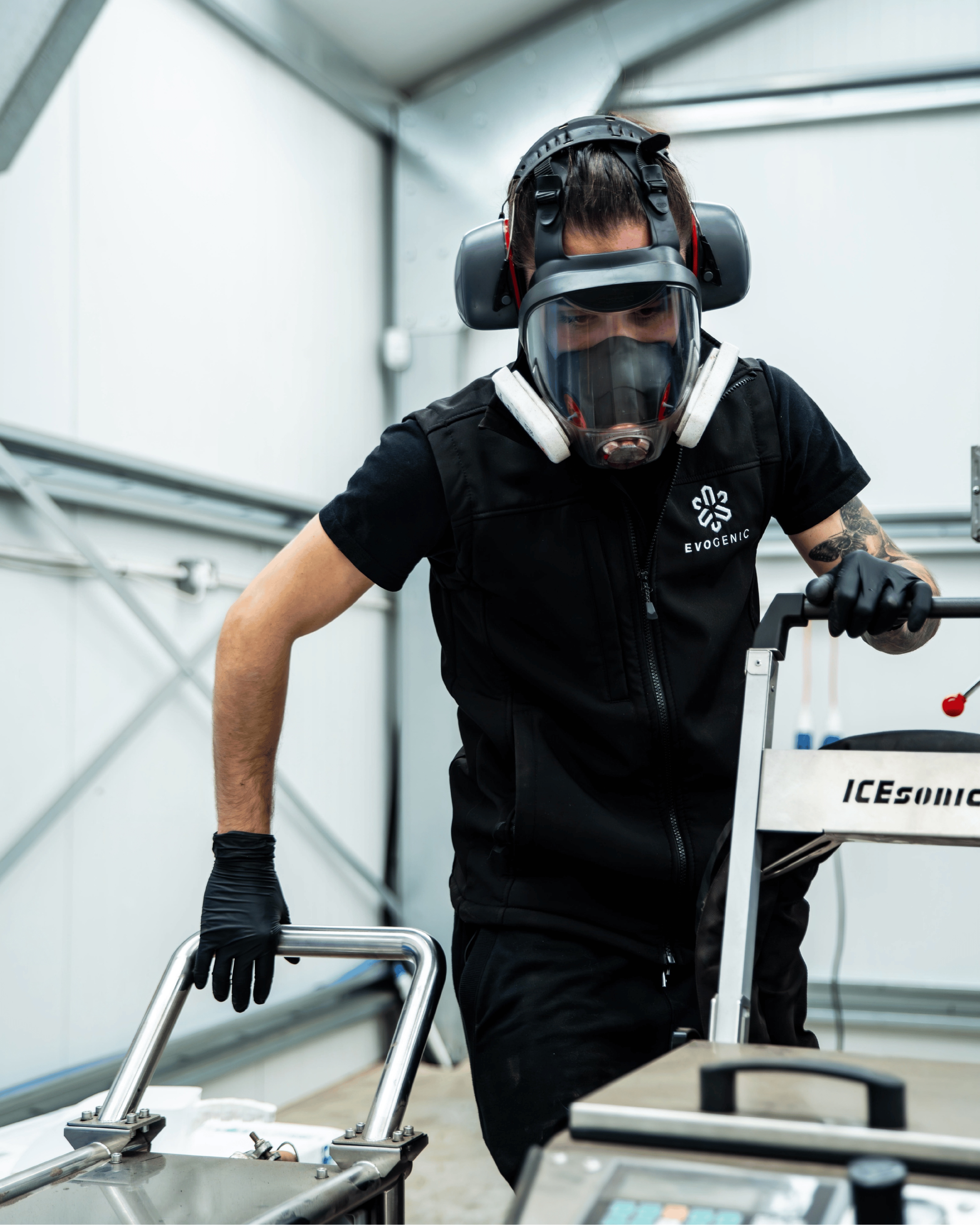 Technician with protective gear setting up dry ice blasting machines 