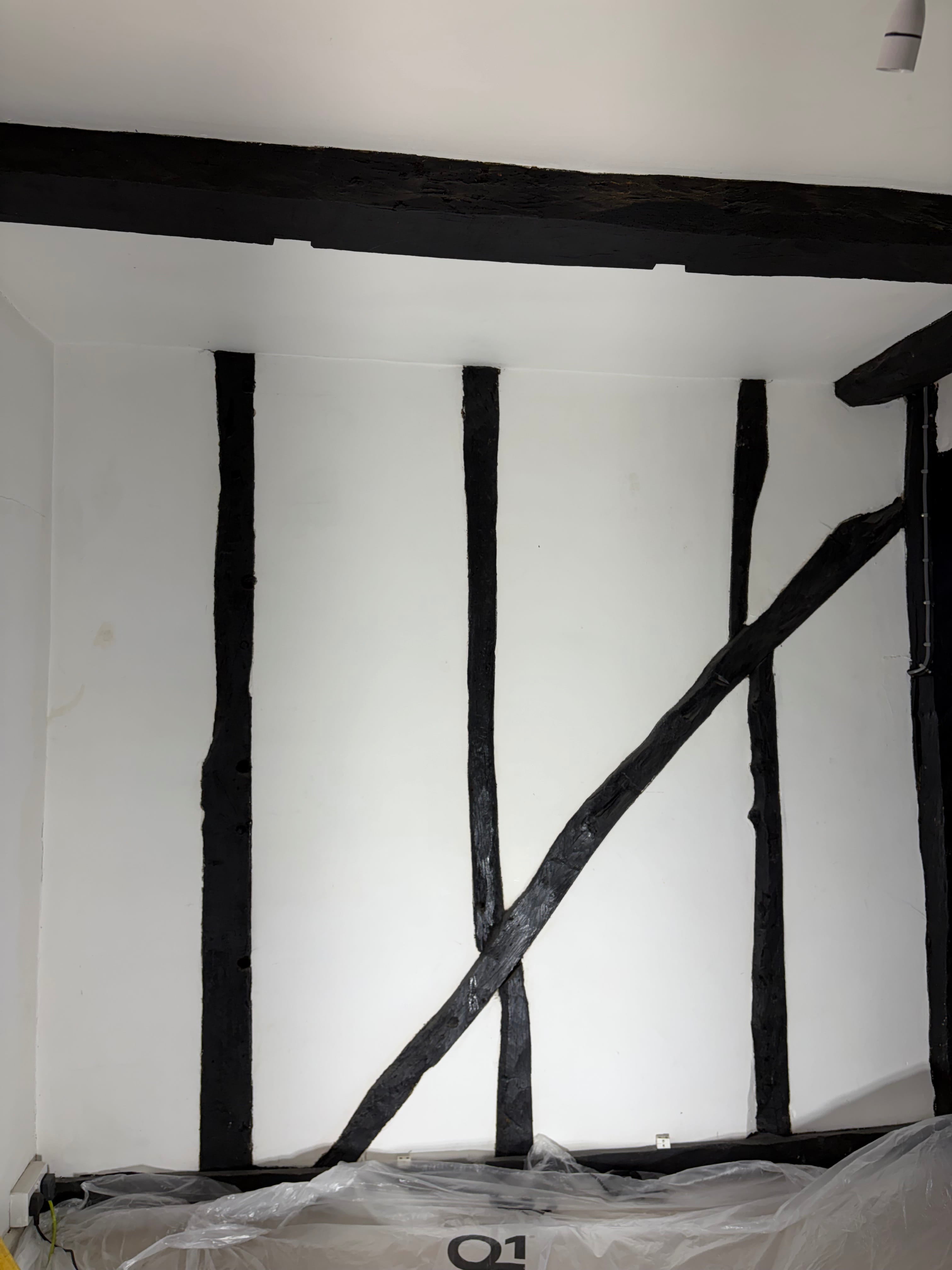 Wooden beams painted black before dry ice blasting paint removal