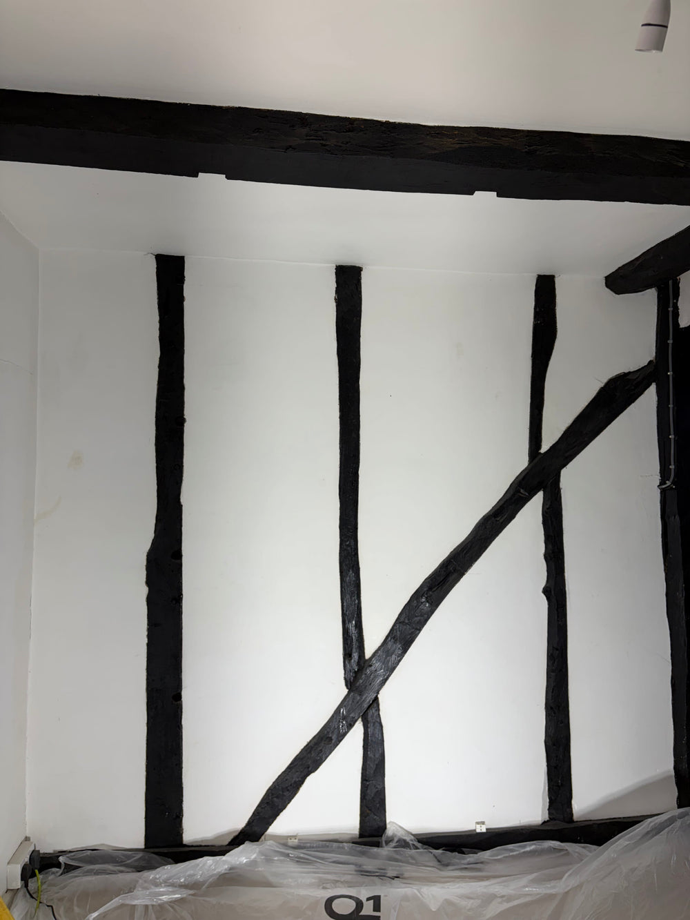 Wooden beams painted black before dry ice blasting paint removal