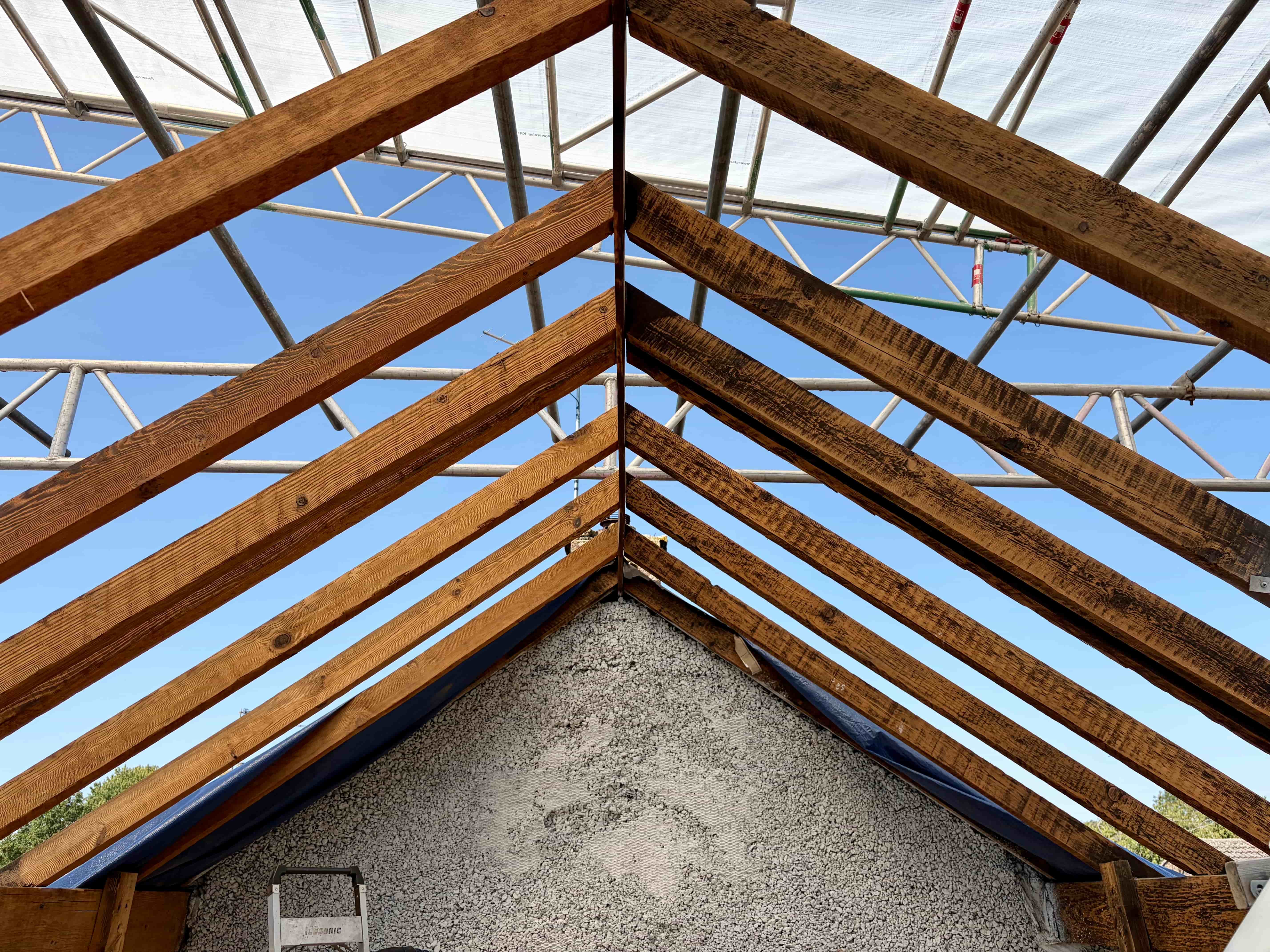 Fire damaged roof timbers with soot and smoke damage before and after dry ice blasting